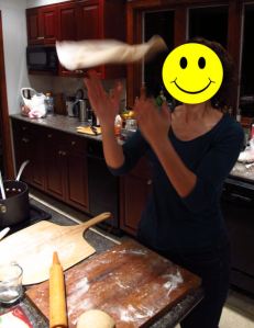 I'm not averse to showing my face on my blog; I've done it before. But this picture is such a horribly unflattering example of it next  to a wonderful example of flying dough. So you get a smiley face.